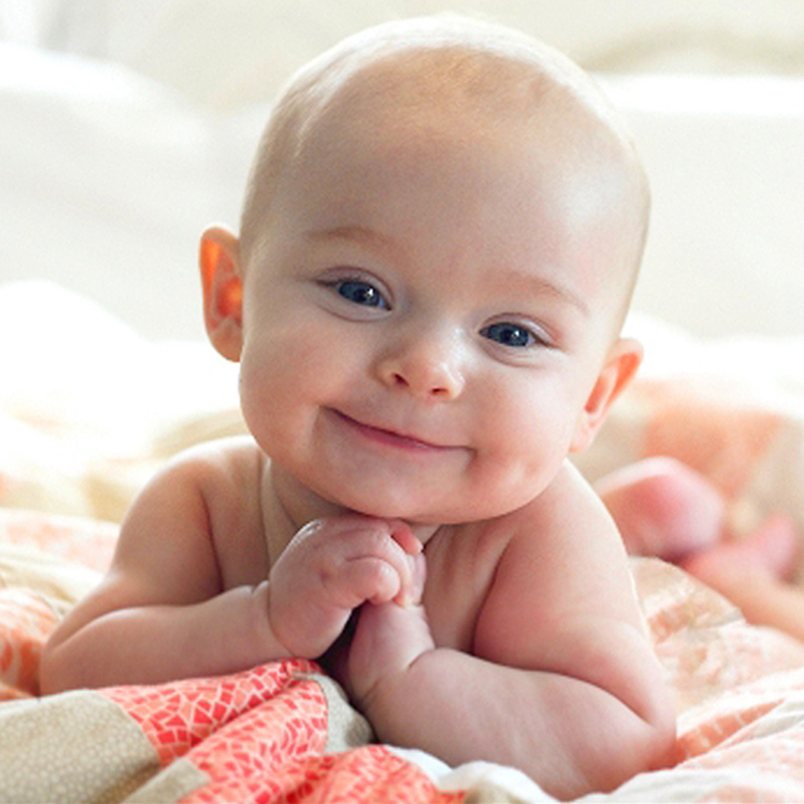 A beaming baby exuding happiness and innocence.