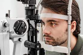Eyecare: A person receiving an eye examination from an optometrist.