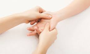 Person applying acupressure to the hand, promoting holistic wellness