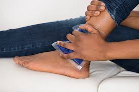 Sprains: Person Applying Ice Pack to Injured Ankle for Pain Relief