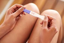 Person holding positive fertility test - Fertility awareness
