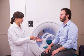 Man positioned on MRI machine for diagnostic imaging.