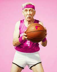 Elderly man in pink shirt playing basketball 