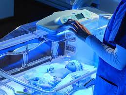 Newborn undergoing phototherapy treatment in an incubator