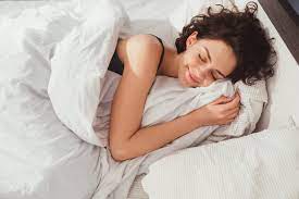 Image of a person resting in bed, promoting relaxation and well-being. Quality rest is essential for overall health and happiness