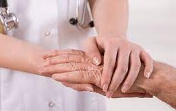 Empathetic nursing care: A nurse holding the hand and consoling a patient with compassion.