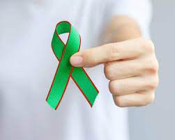 Bowel cancer awareness: Green ribbon with red highlights, a symbol of commemoration and support for those affected by bowel cancer.
