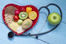 Nutrient-Rich Foods for Managing Cholesterol Levels in Heart-Shaped Bowl Next to Stethoscope - Heart Health and Balanced Nutrition