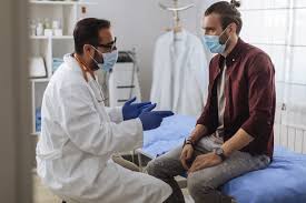 Male patient discussing men's health with doctor during a men's health consultation