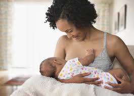 Woman happily breastfeeding her baby - lactational amenorrhea method