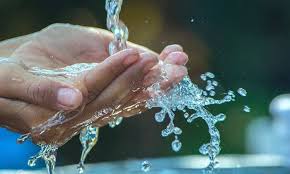 Person washing hands for proper hygiene and health.