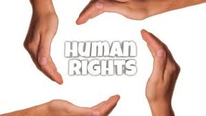 Four hands forming a circle around the words 'human rights' - Symbolizing unity and advocacy for the fundamental principles of equality and justice