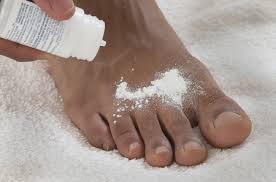 Person applying antifungal cream to the feet