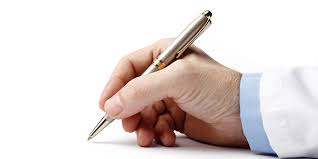 Medical professional's hand with pen, documenting patient information.