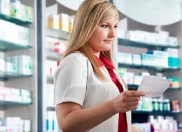 Prescription safety: Pharmacy staff confirming details to prevent errors.