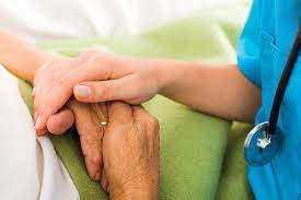 Healthcare professional assessing Parkinson's tremors in patient's hand.