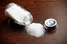 Salt management concept: A toppled bottle of salt on a countertop, symbolizing the significance of salt restriction in hypertension.