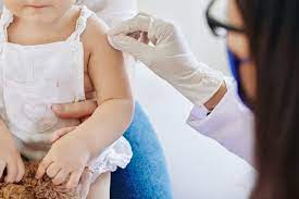 Child receiving vaccine during Immunization Week - left arm
