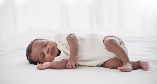 Peaceful night sleepers: Baby soundly asleep on their side in a cozy pose.