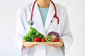 Healthcare professional holding a plate of vegetables for insomnia management