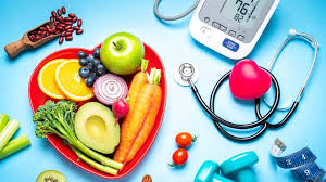 Heart-healthy choices: A heart-shaped container filled with vibrant fruits and vegetables, accompanied by a blood pressure monitor and stethoscope, emphasizing the role of diet in hypertension management.