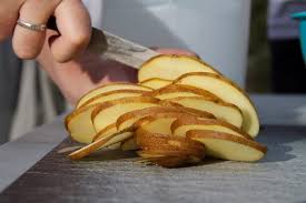 Person slicing a potato: Natural remedy for wounds