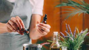 Person applying drops of essential oil