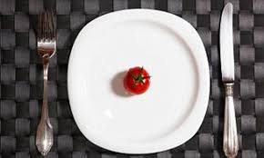Plate with a small tomato