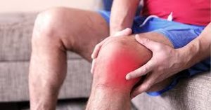 Gout Flare-Up: man holding his left knee in pain