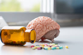 Image depicting a brain alongside an inverted bottle of tablets, illustrating the influence of habit on mental health.