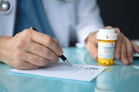 Doctor writing prescription for treatment