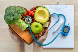 Chronic diseases prevention: Heart-healthy foods in a heart-shaped container being auscultated by a stethoscope 