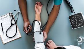 Healthcare professional checking blood pressure