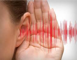 Person using one hand next to their ear, indicating attentive listening for hearing protection