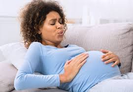 Pregnant woman practicing breathing technique: A serene image illustrating a pregnant woman engaged in focused breathing exercises, an essential aspect of preparing her birth plan.