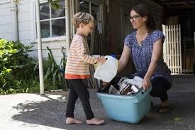 Child helping their mother wash shoes by carrying water - Parenting