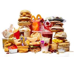 An image displaying a variety of unhealthy food items high in sugar and fat, emphasizing the detrimental impact of these choices on health