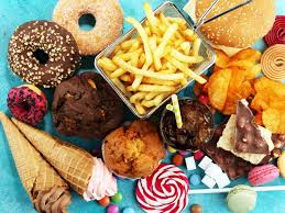 Array of sugary and fatty foods - An image displaying a variety of harmful foods high in sugar and fat, emphasizing the detrimental effects of such dietary choices.