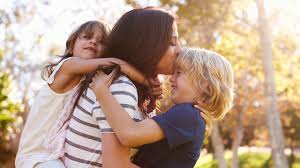 Mother bonding with her two kids in the park