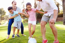 Family enjoying outdoor football activity. Share moments of joy and bonding, engaging in a refreshing and active family time.