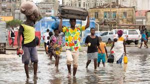 Aftermath Image: People Rebuilding, Carrying Possessions