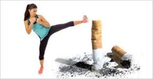 A determined woman kicking a cigarette butt, symbolizing her commitment to a healthier lifestyle and the decision to quit smoking. A powerful image capturing the triumph over a harmful habit.