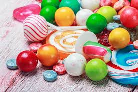 Diverse assortment of candies, highlighting the appeal and potential health consequences of consuming foods with empty calories.