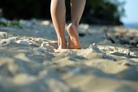 Person walking in the sand- Essential foot care for circulatory health