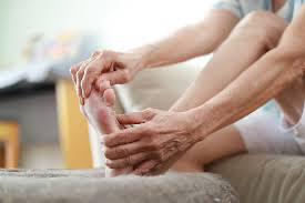 Person examining their feet - Vital steps for diabetes and circulatory health.