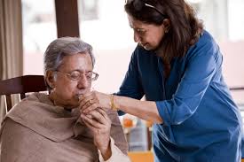 A wife lovingly cares for her sick husband, offering him medication to alleviate his fever and discomfort and aid in his recovery.