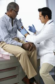 Man receiving an injection during his doctor's visit