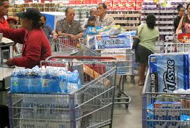 Individuals shopping for storm essentials at a supermarket