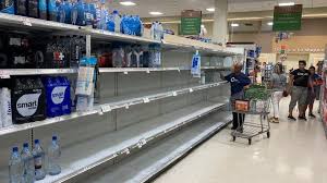 Empty supermarket shelves during storm preparation