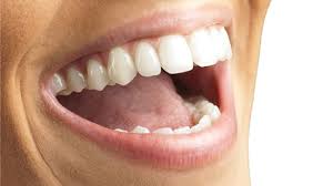 Happy person displaying healthy teeth, preventing dental problems.